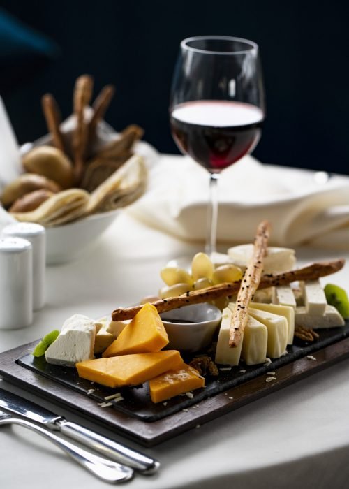 cheese plate with glass of wine